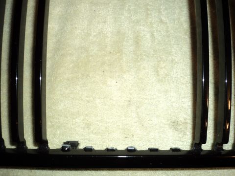 2004 Mercury Grand Marquis - Close-up of a black grille, likely a replacement part, with visible mounting hardware.