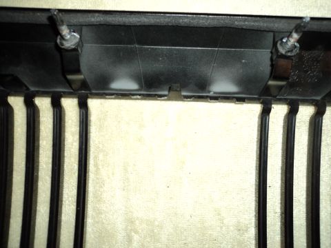 2004 Mercury Grand Marquis - Detail of a vehicle's front grille assembly, showing mounting points and the grille's structure.