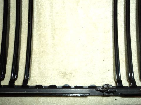 2004 Mercury Grand Marquis - Close-up of a black car grille with vertical bars and visible latching hardware.