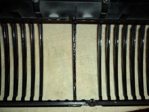 2004 Mercury Grand Marquis - A close-up view of a vehicle's front grille, showing its vertical bar design.