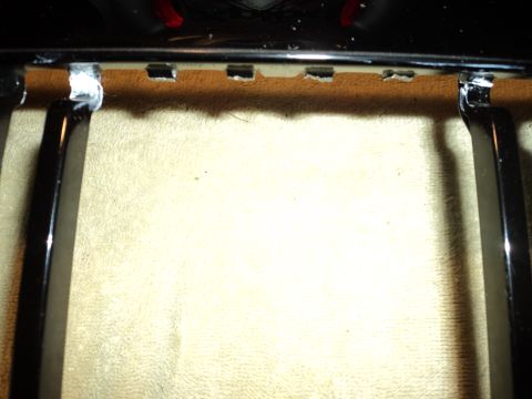 2004 Mercury Grand Marquis - Detail of a car's grille assembly, showing chrome accents and attachment points.