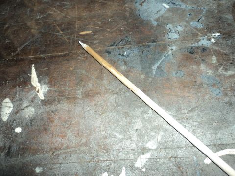 2004 Mercury Grand Marquis - A wooden dowel lies on a stained and scratched workbench.