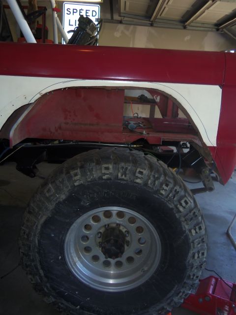 1968 Ford Bronco - This vehicle shows modifications to the fender and has large off-road tires. A speed limit sign is visible in the background.