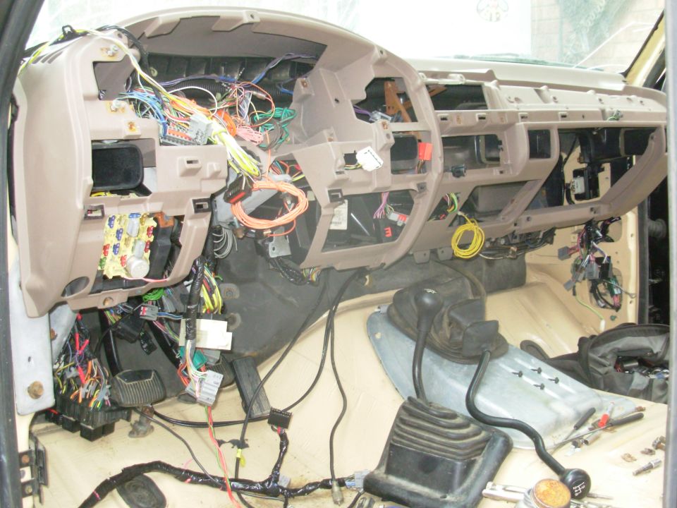 After a false start last night (the inside A/C box was slightly too high), it's IN!!!  I've started fishing the wires through to where they go, and preparing to place all the new switches that I've added.  Surprisingly, I still haven't found any errors in all this mess, other than a few missing tags to remind me what some of the new wires are for.