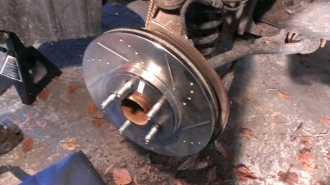 2003 Mercury Marauder - Close-up of a new brake rotor and suspension components, likely during a repair.