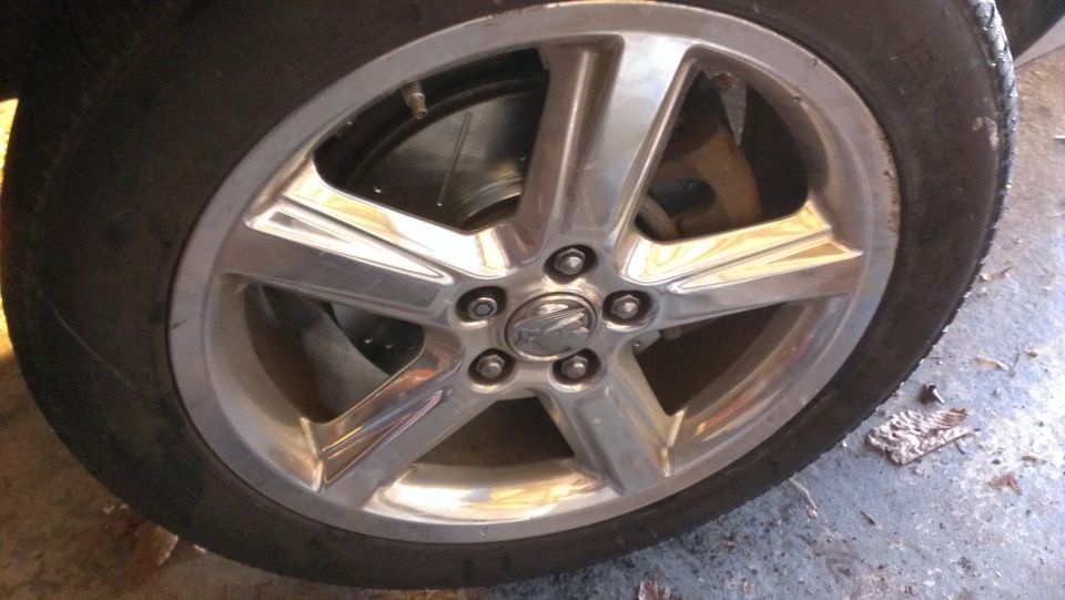 Chrome wheel with visible brake rotor and caliper