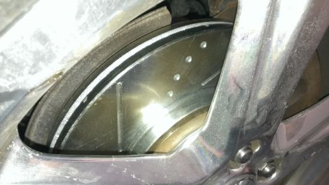 2003 Mercury Marauder - Close-up of a slotted brake rotor and caliper, likely from a performance vehicle.