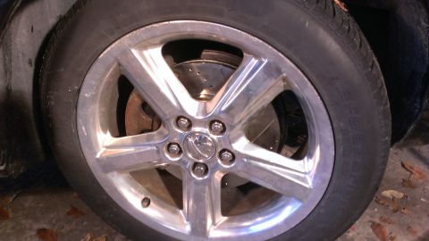 2003 Mercury Marauder - A close-up view of a shiny alloy wheel and the brake rotor behind it on a 2003 Mercury Marauder.