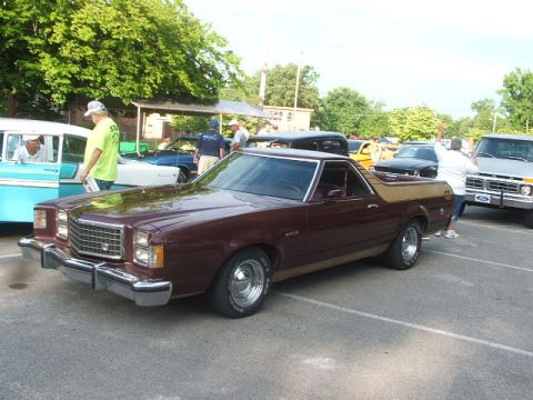 1972 Ford Ranchero - A maroon and tan Ford Ranchero is parked at an outdoor car show with other vehicles present.