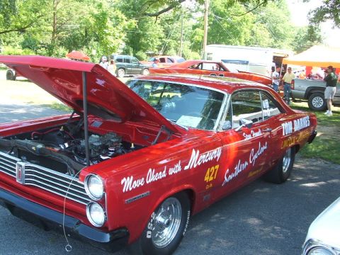 1972 Ford Ranchero - This red Mercury Comet, likely a 1966 model, is displayed with its hood open, revealing the engine and race-inspired graphics.