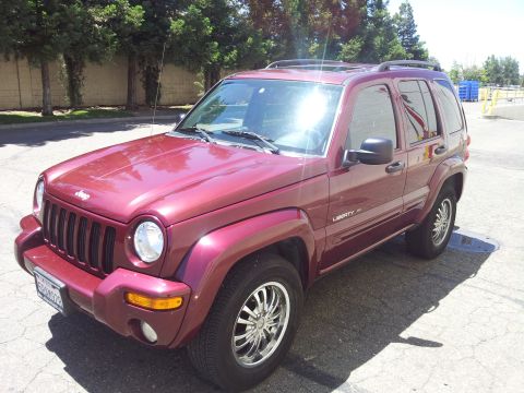 2005 Chevrolet Venture - A red Jeep Liberty SUV is shown from a three-quarter front view.