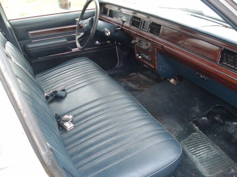1991 Ford LTD Crown Victoria - Interior view of a car showing the front bench seat and dashboard.