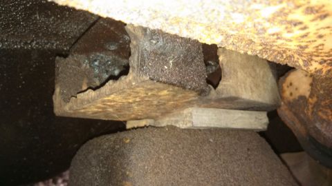 1979 Ford Bronco - Close-up view of heavily corroded undercarriage components, showing significant wear and tear.