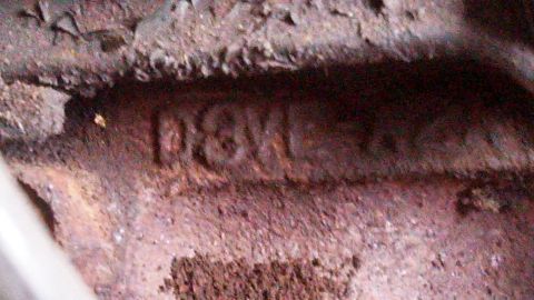 1979 Ford Bronco - Close-up of a rusty part with stamped text 'P8K1' visible.