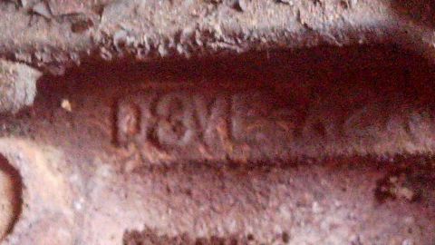 1979 Ford Bronco - Embossed casting numbers 'D8VE' are visible on this rusty metal engine component.