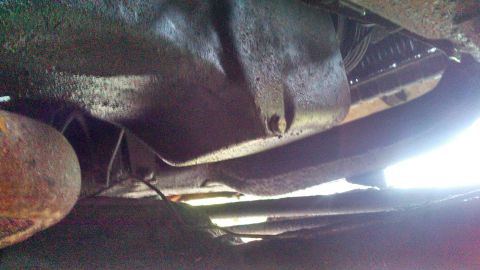 1979 Ford Bronco - This photo shows the underside of a vehicle, focusing on the oil pan and exhaust system.