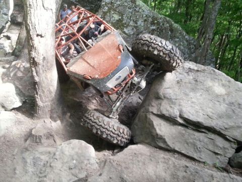 1967 Ford Mustang - This off-road vehicle is navigating a difficult rocky terrain, with its tires gripping the boulders.