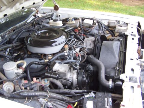 1991 Ford LTD Crown Victoria - The engine compartment of a vehicle, showing the air intake and cooling system components.