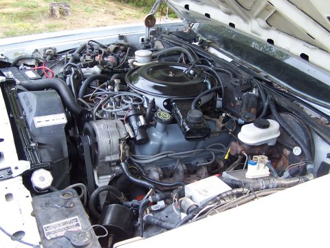 1991 Ford LTD Crown Victoria - The engine bay of a car, showing various components and wiring.