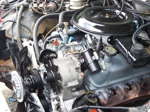 1991 Ford LTD Crown Victoria - Close-up view of a vehicle's engine compartment, showing various mechanical components and wiring.