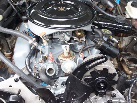 1991 Ford LTD Crown Victoria - Close-up view of a car's engine bay, showing various components like the air filter housing and distributor cap.