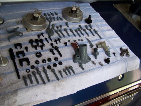 1991 Ford LTD Crown Victoria - A collection of automotive parts, including gauges and fasteners, are neatly arranged on a towel.