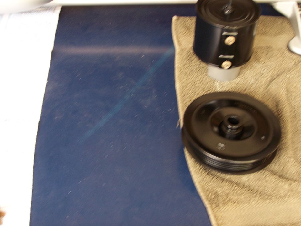 Black pulley and air filter housing on a towel