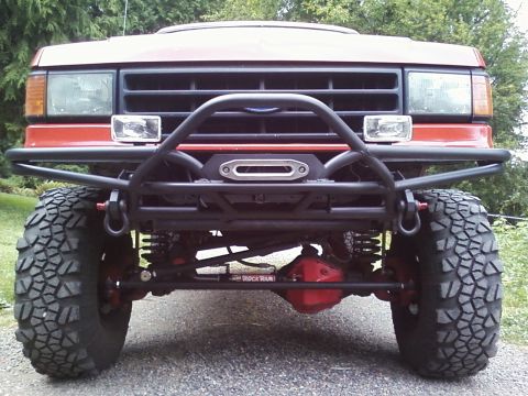 1989 Ford Bronco - Front view of a 1989 Ford Bronco a custom tube bumper with a winch and large off-road tires.
