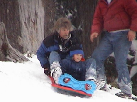 1982 Ford Bronco - People enjoy a snowy day sledding down a hill.