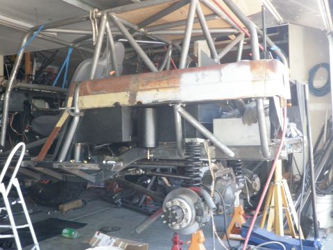 1961 International Scout 800 - Custom off-road vehicle chassis and roll cage assembly in a garage setting.
