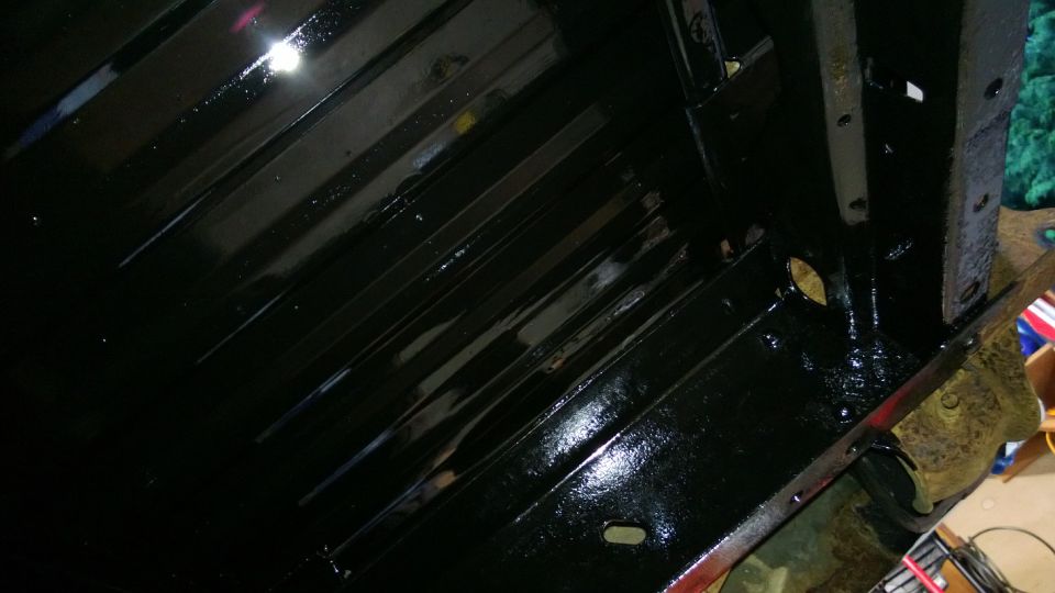 Black painted undercarriage with ribbed metal panels and visible bolts