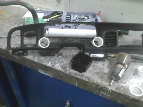 2003 Ford Crown Victoria - Dashboard parts and tools are laid out on a workbench, suggesting a repair or customization project.