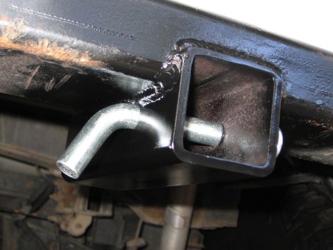 1993 Toyota 4Runner - Close-up of a trailer hitch receiver and pin, indicating a custom or aftermarket part.