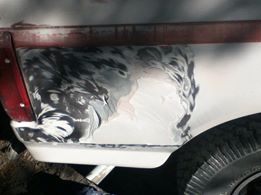 1996 Ford Bronco - Bodywork in progress on a Ford Bronco, focusing on rust repair and preparation for paint.