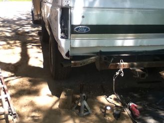1996 Ford Bronco - Rear view of a 1996 Ford Bronco, showing the driver side quarter panel and tailgate.