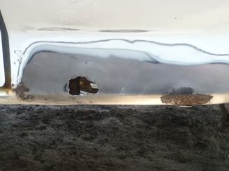 1996 Ford Bronco - This vehicle's body panel shows significant rust damage and repair work.
