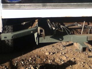 1996 Ford Bronco - Close-up view of the rear frame and tow hitch assembly of a white vehicle.