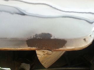 1996 Ford Bronco - This image shows a close-up of a vehicle's lower body panel, revealing rust and the SuperMotors website logo.