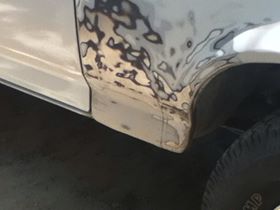 1996 Ford Bronco - This vehicle's side panel is undergoing bodywork, with primer and filler visible.