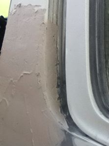 1996 Ford Bronco - Close-up of body filler application on a vehicle's door frame, with the Supermotors.net logo in the corner.