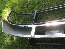 1996 Ford Bronco - A front bumper and brush guard are shown resting on grass, with the SuperMotors.net logo in the lower portion of the image.