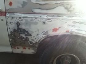 1996 Ford Bronco - This vehicle's bodywork is undergoing repairs, with visible filler and primer applied to the side panel.