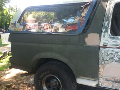 1996 Ford Bronco - This Ford Bronco is undergoing body repairs, with primer and masking tape visible on the exterior.