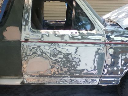 1996 Ford Bronco - This 1996 Ford Bronco is in the process of body repair, showing areas of primer and filler on its side panel.