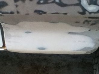 1996 Ford Bronco - Bodywork is underway on this vehicle, with filler applied to a damaged section.
