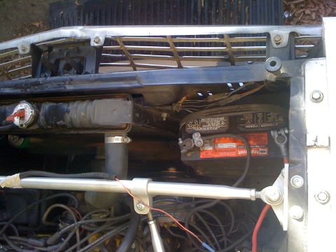 1964 Ford Ranchero - Close-up view of a vehicle's engine bay, focusing on the battery and radiator components.