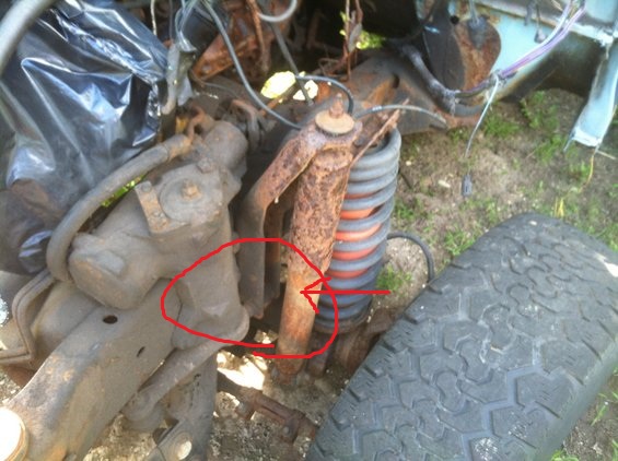 rusted suspension parts and tire from a vehicle