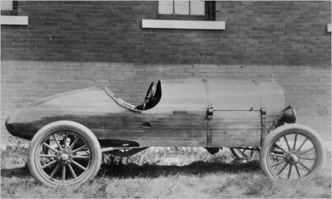 1909 Ford Model T - This custom-built vehicle features a unique wooden body and open cockpit, unlike a standard 1909 Ford Model T.
