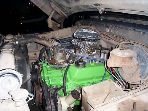 1979 Ford Bronco - The engine bay shows a green-painted engine block with aftermarket carburetor and air filter, suggesting a custom build.