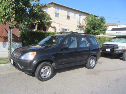 2003 Honda CR-V - Black 2003 Honda CR-V parked on street next to another vehicle.